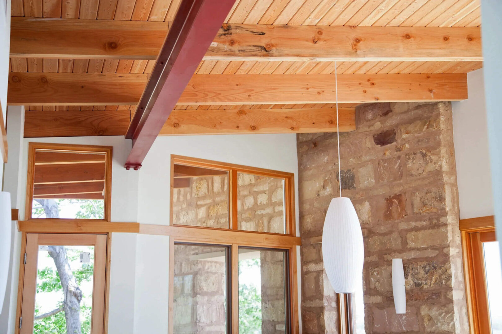 home interior with wooden ceilings and a hanging lamp