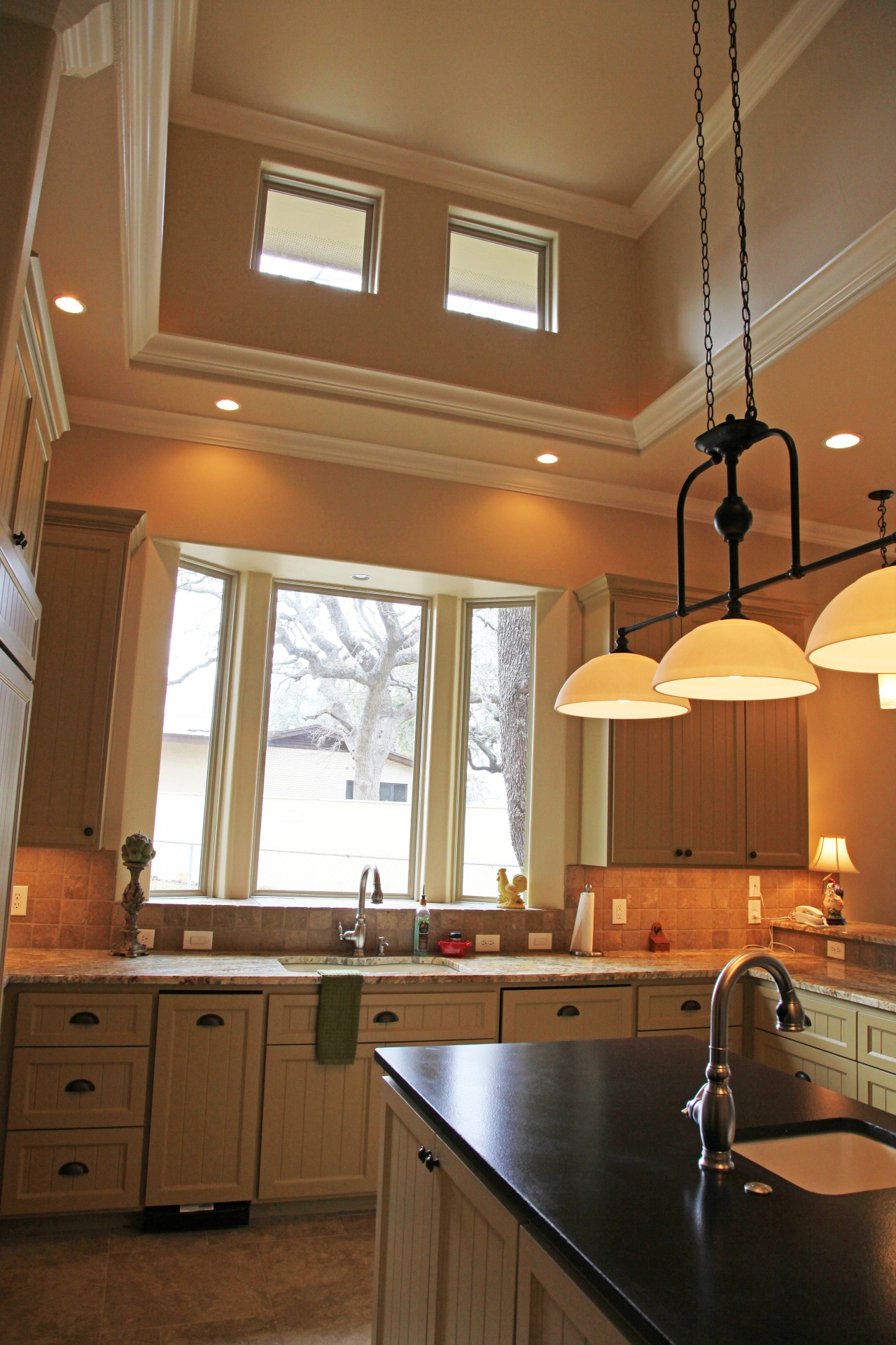 kitchen with high ceiling and chandeliers