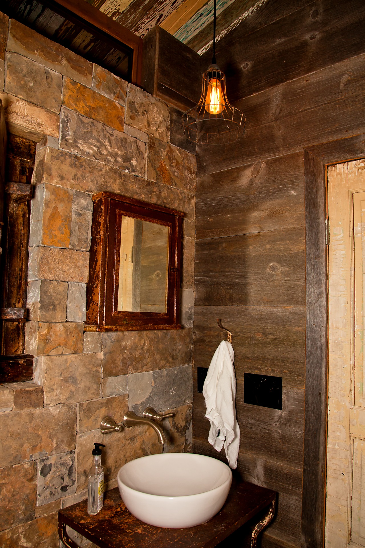 vintage bathroom area with brown bricks and wooden walls