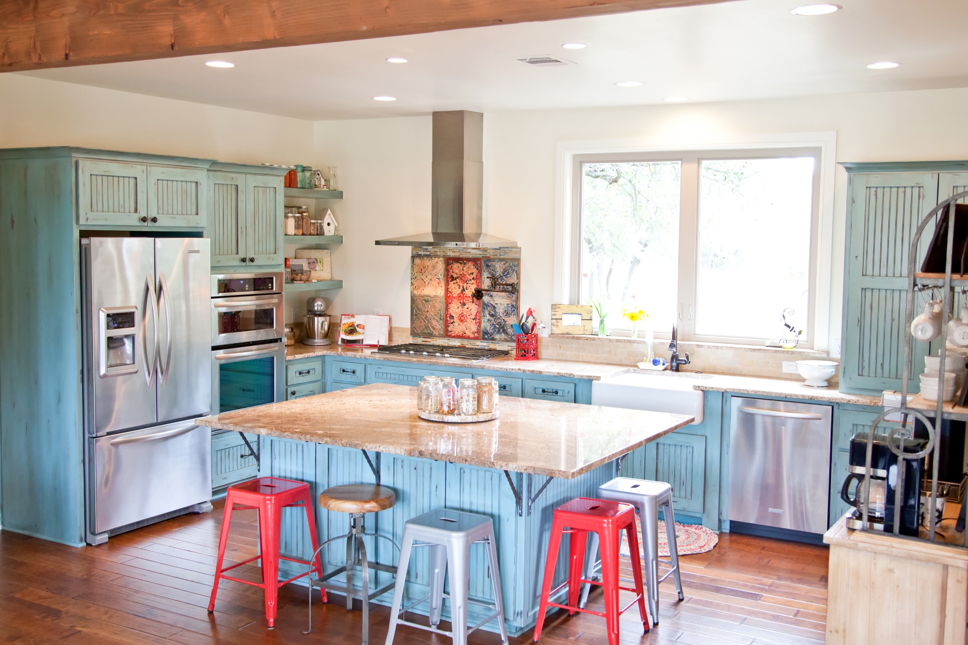 blue kitchen countertop with colorful chairs